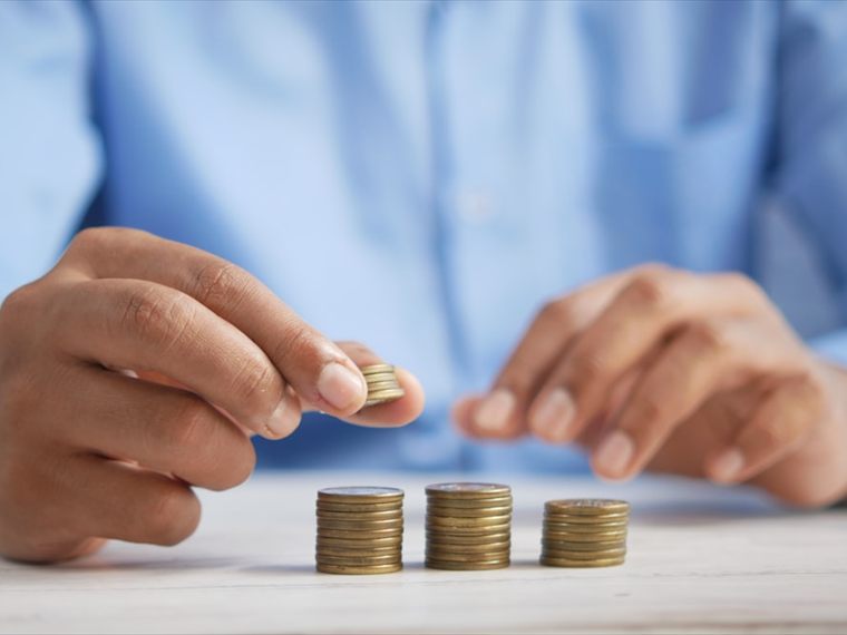 Stacking coins into growing columns, representing long-term tax planning